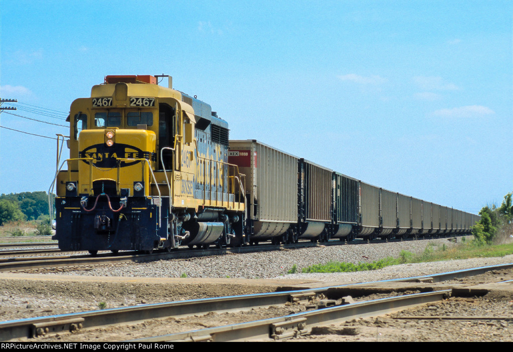 BNSF 2467, ex ATSF EMD GP30, leads a westbound empty hopper train at Eola Yard 